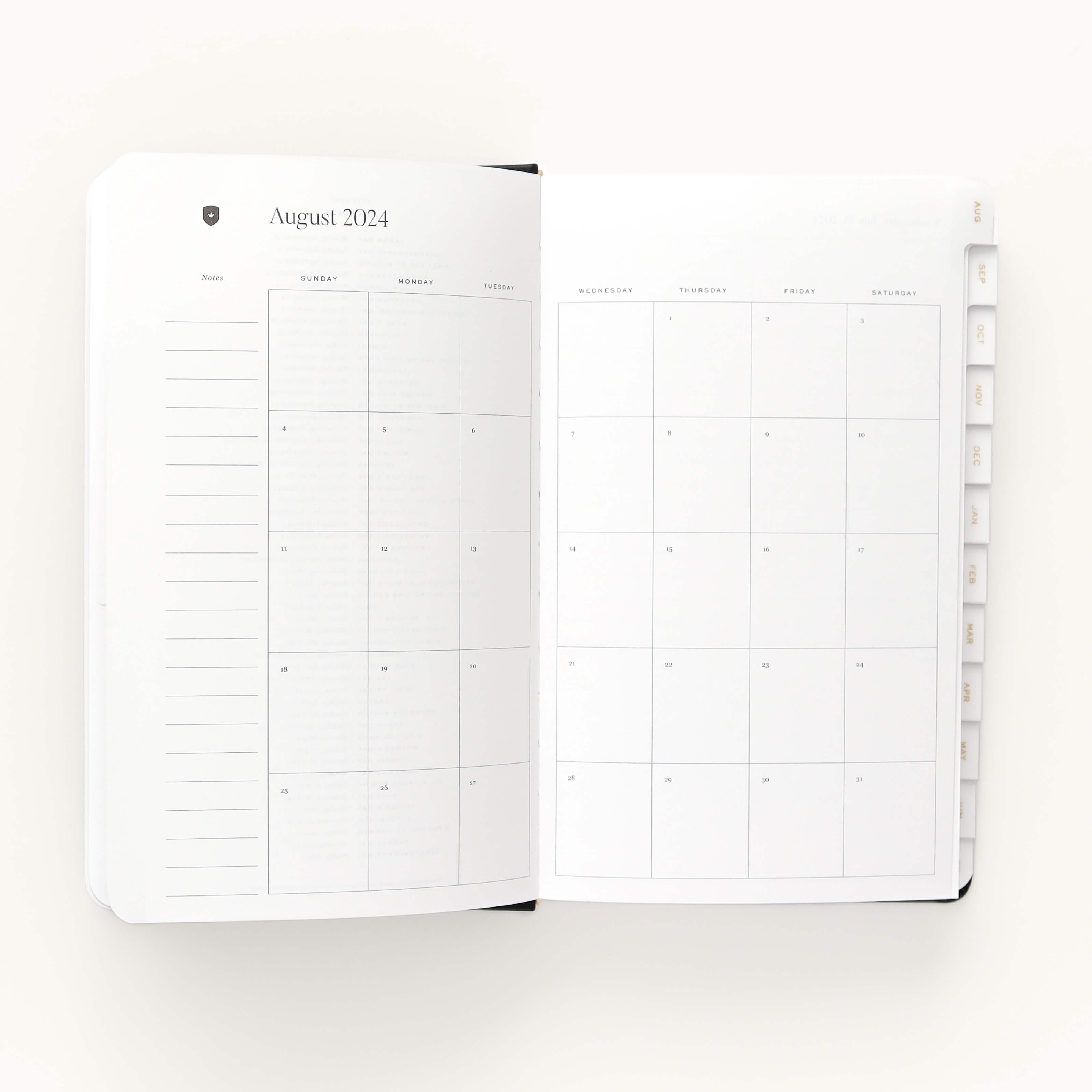 The 2024-2025 Daily Dapperdesk Planner - Black Tie by Simplified has a leatherette cover and opens to a monthly calendar view for August 2024, with lined note sections on the left and a dated grid on the right, plus edge tabs for easy navigation.