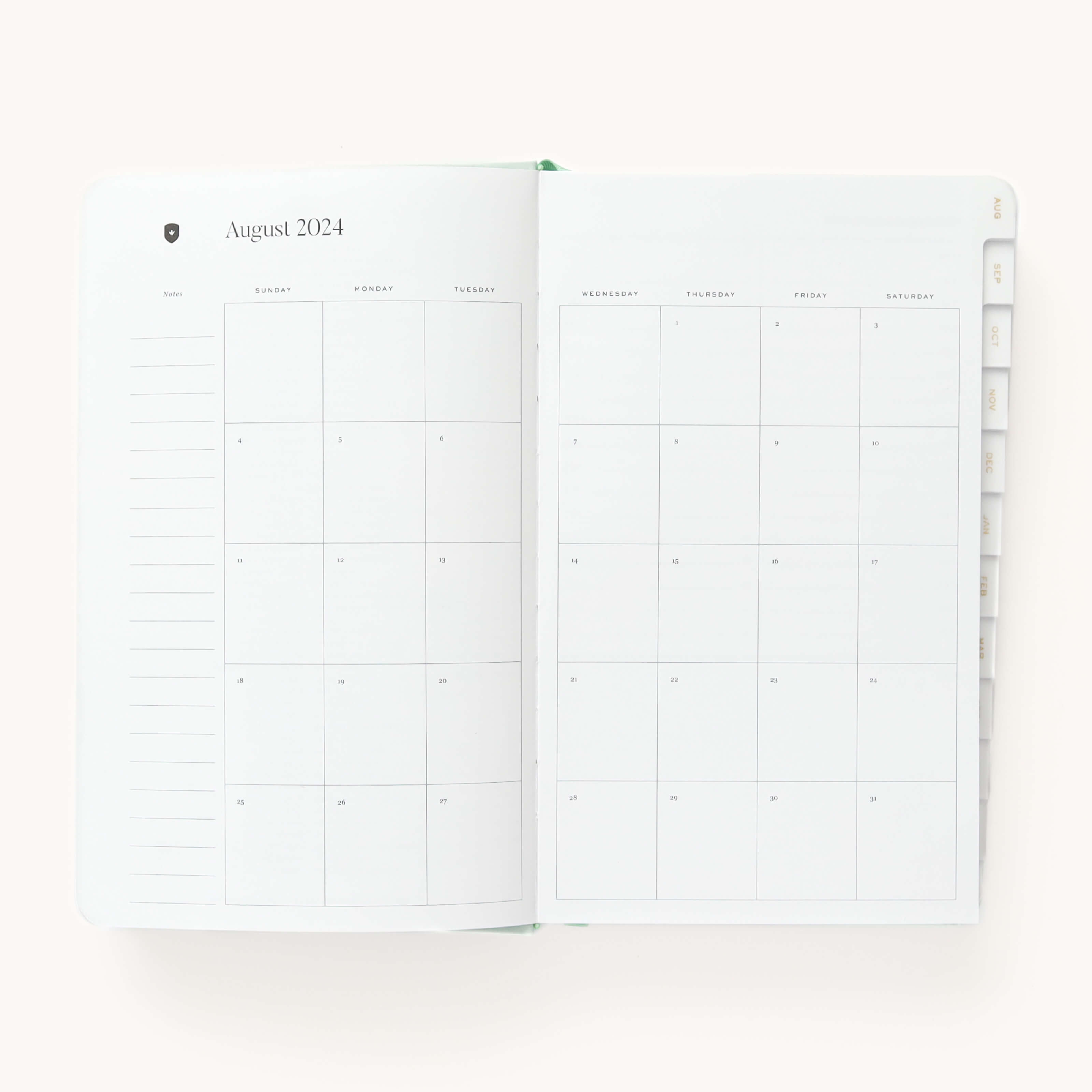 Monthly spread in the 2024-2025 Daily Dapperdesk Planner in the Sea Salt leatherette cover featuring mylar tabs with gold foil details.