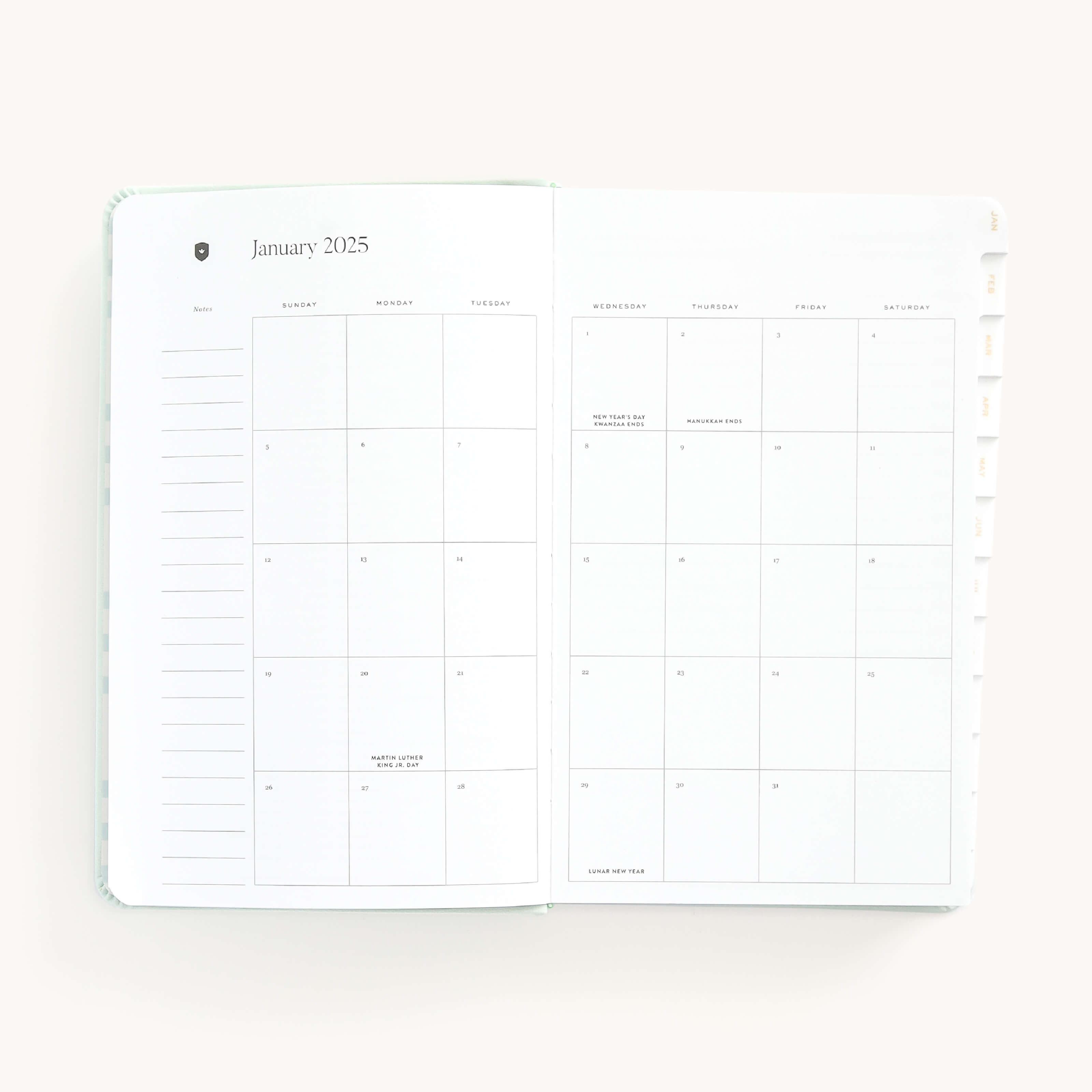 Monthly spread in the 2025 Daily Dapperdesk Planner in the Sea Salt leatherette cover featuring mylar tabs with gold foil details.