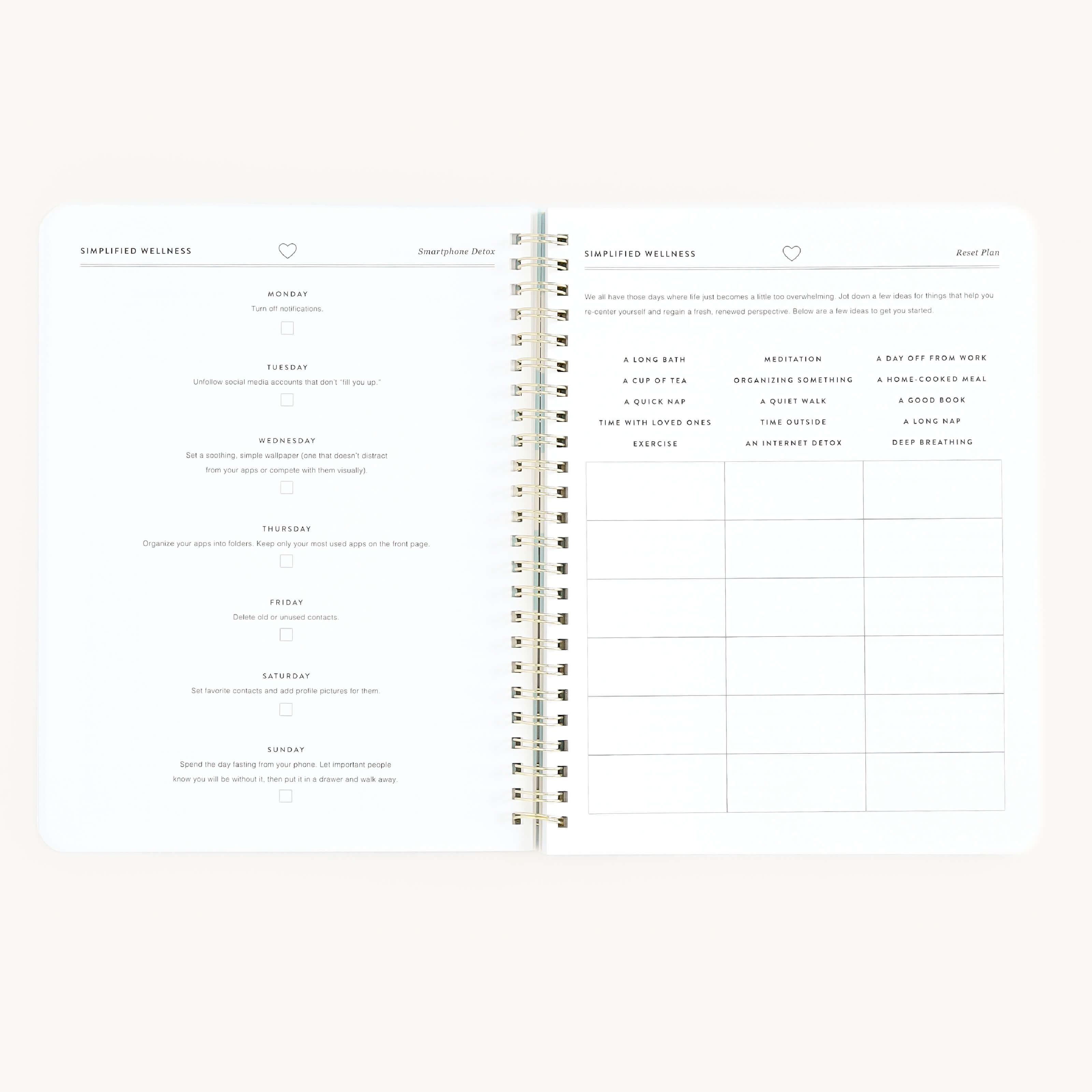 The Simplified Workbook - Wellness features an open layout with sections for daily intentions from Monday to Saturday on the left page and a goal-tracking grid on the right, all spiral-bound to help you prioritize self-care throughout your week.