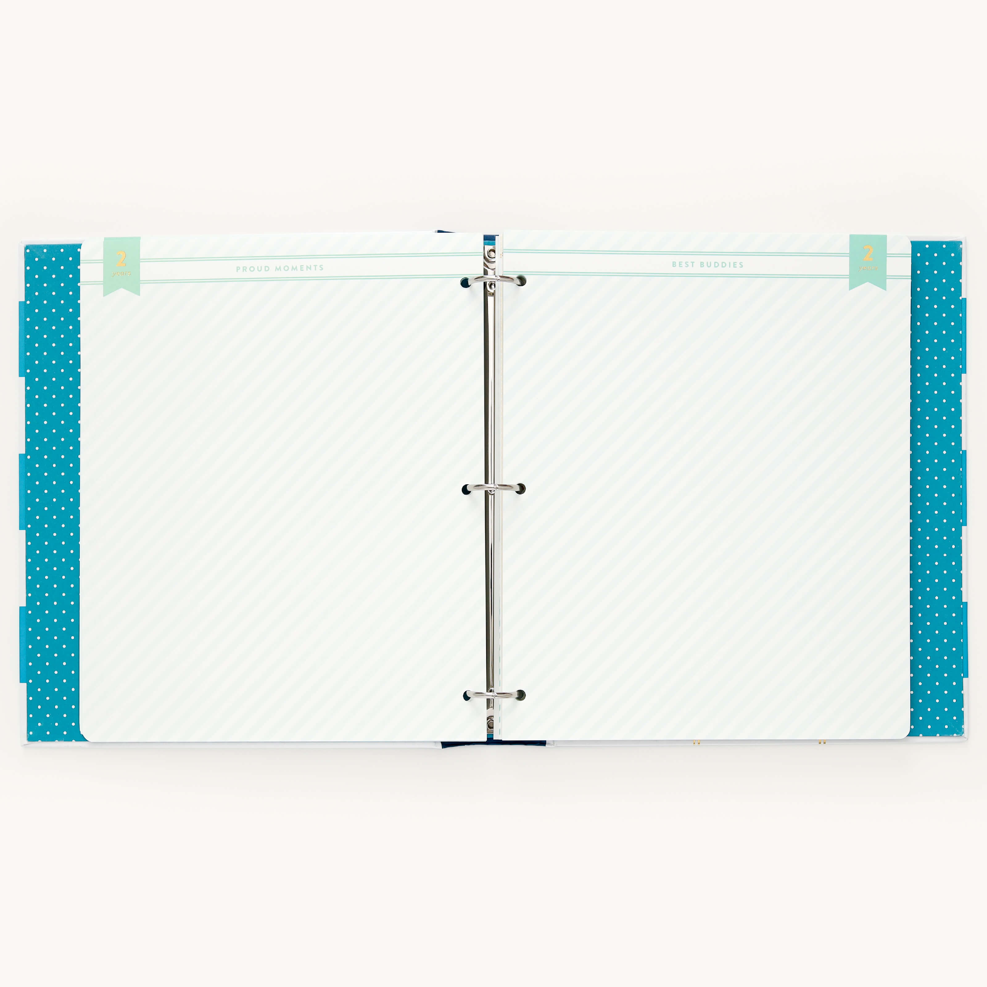 The Simplified Big Kid Book - Teal is an open binder with a three-ring mechanism featuring blank lined pages with polka dot borders, ideal for documenting child growth. It has decorative tabs labeled Proud Moments and Best Words in light blue and teal.