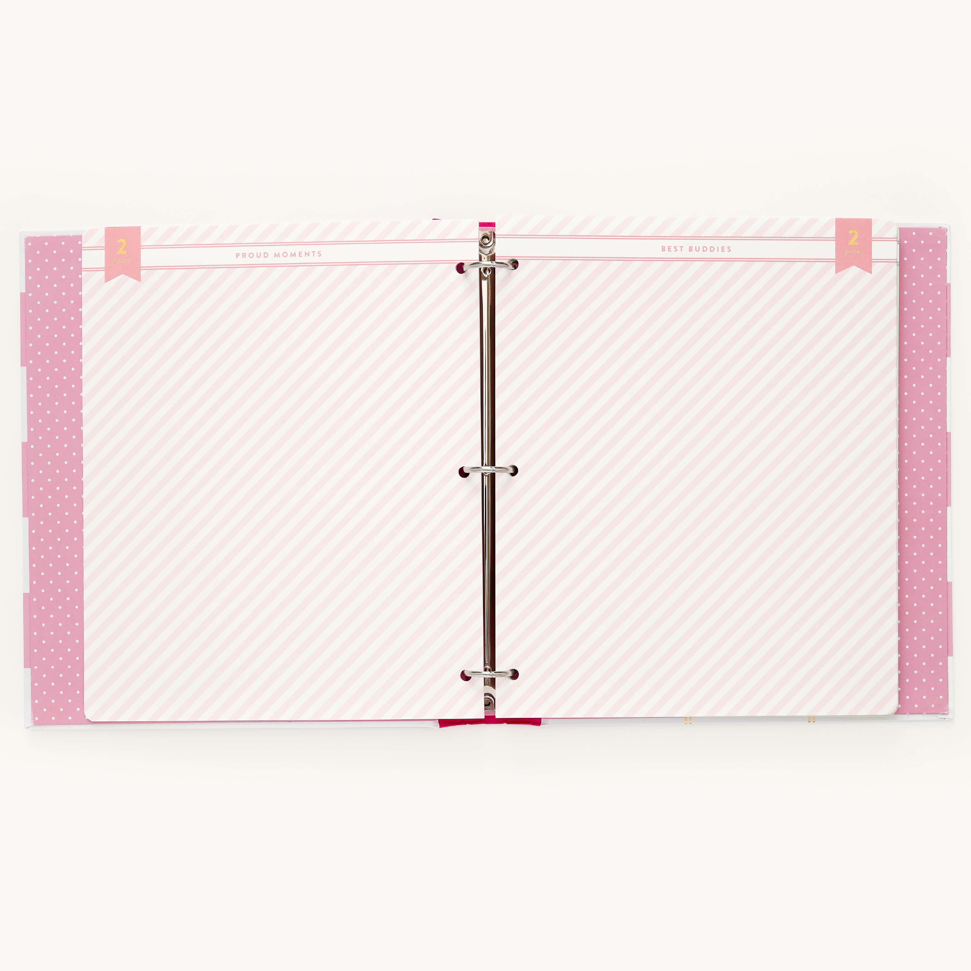 The Big Kid Book - Raspberry by Simplified is an open binder with a ring mechanism, showcasing colorful pages with light pink diagonal stripes. Proud Moments and Best Bodies are on the pink banner, while pink polka-dotted dividers frame the growing childs adventures.