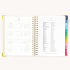 2025 Weekly Simplified Planner by Emily Ley in the Blush Block cover design open to the yearly calendar overview and holidays list. Features a two-page spread with a full 12-month calendar view on the left and important U.S. holidays on the right. 