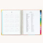 2025 Weekly Simplified Planner by Emily Ley in the Cabana Pinstripe cover design open to the yearly calendar overview and holidays list. Features a two-page spread with a full 12-month calendar view on the left and important U.S. holidays on the right. 