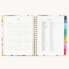 2025 Weekly Simplified Planner by Emily Ley in the Savannah Blooms cover design open to the yearly calendar overview and holidays list. Features a two-page spread with a full 12-month calendar view on the left and important U.S. holidays on the right. 