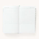 2024-2025 Daily Dapperdesk Planner by Emily Ley in the Sea Salt leatherette cover open to a two-page daily spread featuring Sunday and Monday. Features a clean, minimalistic design with lined sections for daily tasks, to-do lists, and notes.