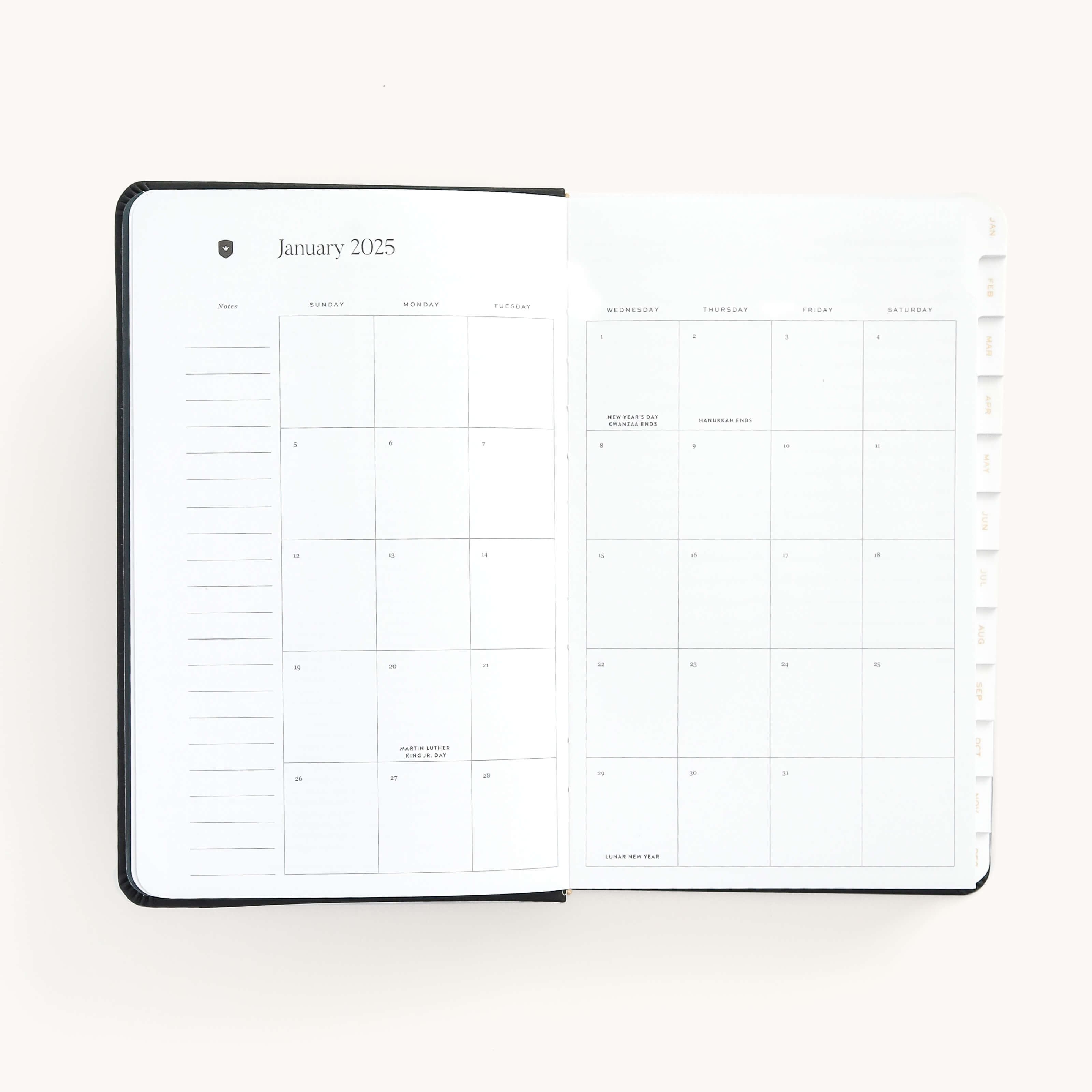 Monthly spread in the 2025 Daily Dapperdesk Planner in the Black Tie leatherette cover featuring mylar tabs with gold foil details.