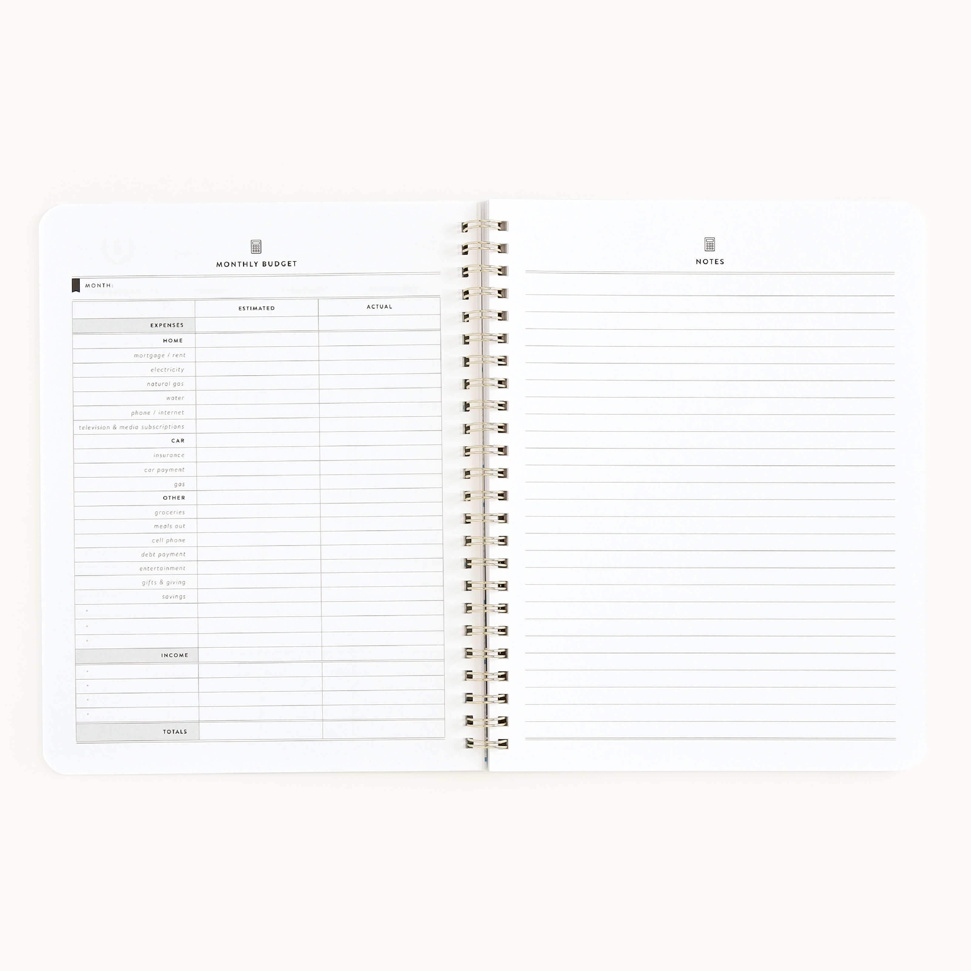 The Simplified Workbook - Finances features an open spiral-bound design. The left page has a monthly budget layout with categories and columns for estimated and actual amounts, perfect for financial goals. The right page is lined for notes, ideal for managing money effectively.