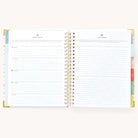 Simplified Planner by Emily Ley open to the Weekly and Daily Routine planning pages. The left page provides a structured layout for organizing weekly routines with designated sections for each weekday, while the right page features space for detailing morning and evening daily routines.