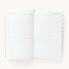 2024-2025 Daily Dapperdesk Planner by Emily Ley in the Sea Salt leatherette cover open to a two-page daily spread featuring Tuesday and Wednesday. Features a clean, minimalistic design with lined sections for daily tasks, to-do lists, and notes.