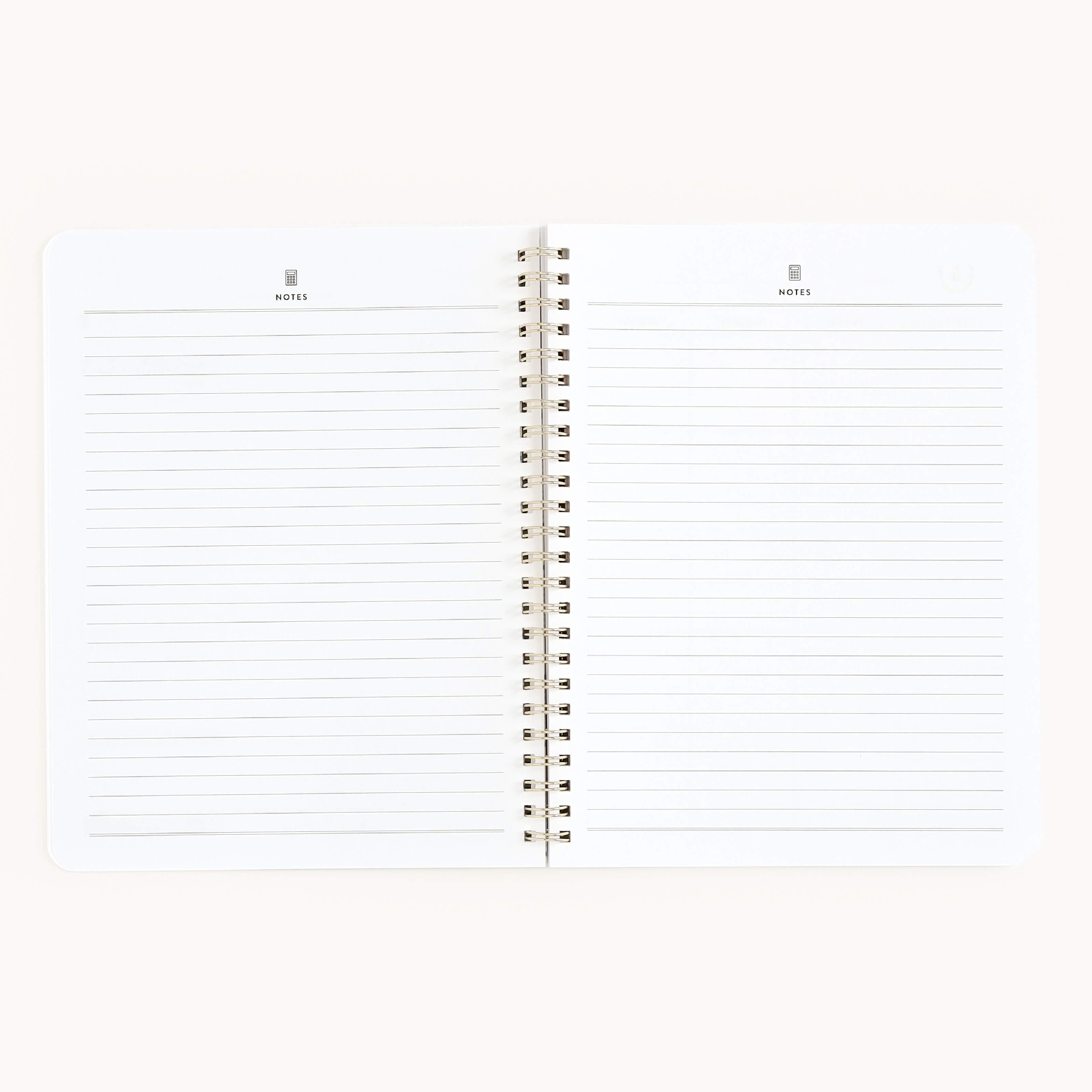 The Simplified Workbook - Finances is a spiral-bound notebook with lined pages labeled Notes at the top, ideal for tracking financial goals. It is set against a plain, light background.