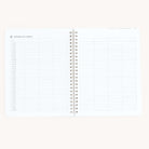 Open the Simplified workbook - Travel Planning, a spiral-bound guide with a two-page spread for extended trip itineraries. Each page includes grids for time and activities, ideal for detailed daily scheduling and travel plans.