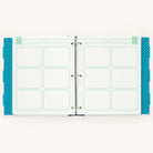 The Big Kid Book - Teal by Simplified is an open binder with a two-page spread featuring grid sections labeled quotes and memories for writing. Tabs and teal polka dot accents adorn the edges, creating a memorable tool for tracking your childs growth.