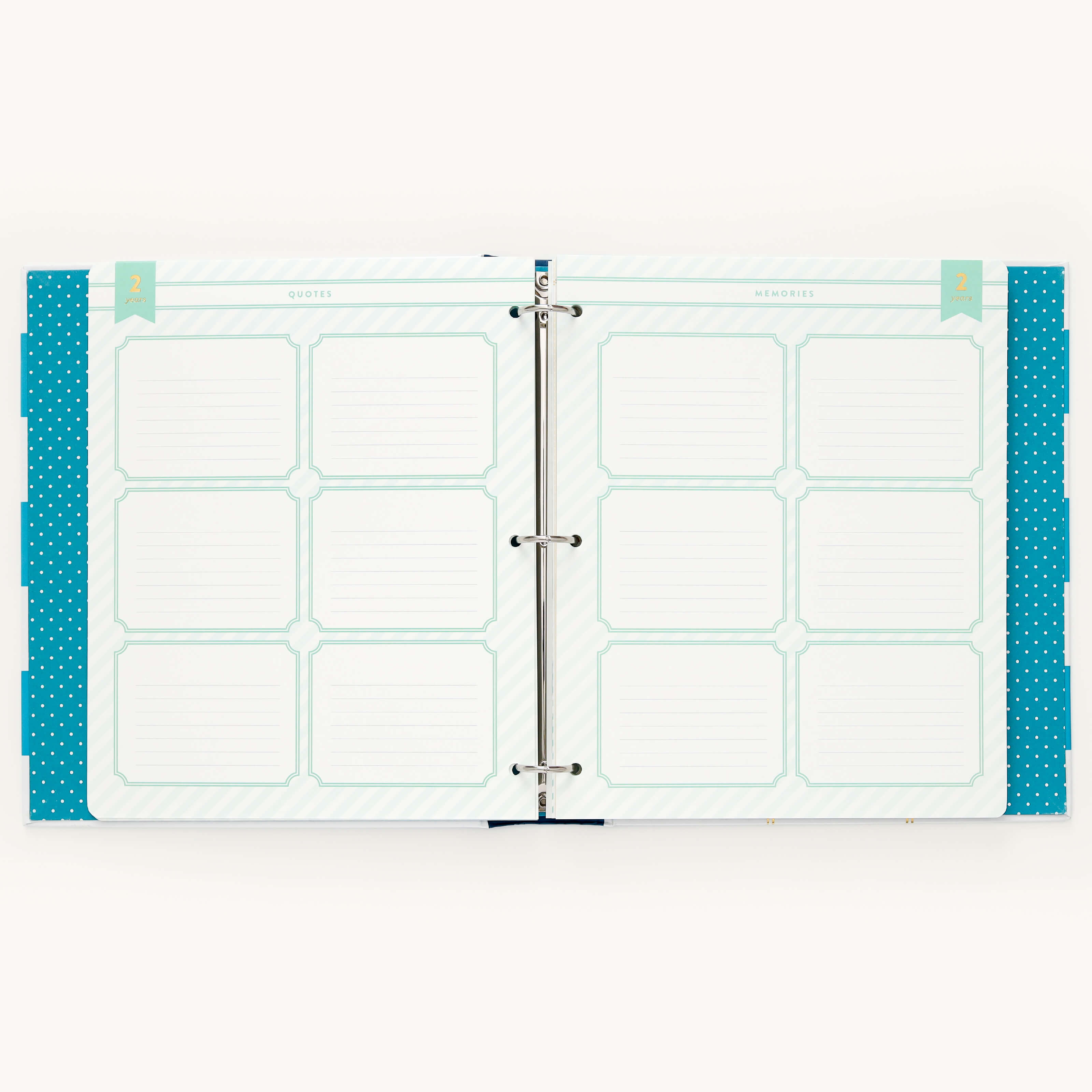 The Big Kid Book - Teal by Simplified is an open binder with a two-page spread featuring grid sections labeled quotes and memories for writing. Tabs and teal polka dot accents adorn the edges, creating a memorable tool for tracking your childs growth.