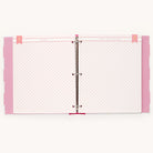 Open the Raspberry Big Kid Book by Simplified, featuring vibrant pink and white diagonal striped pages with pink polka-dotted tabs on the left. A pink banner with Simplified and What a Year It Has Been completes this colorful binder capturing a childs adventures.