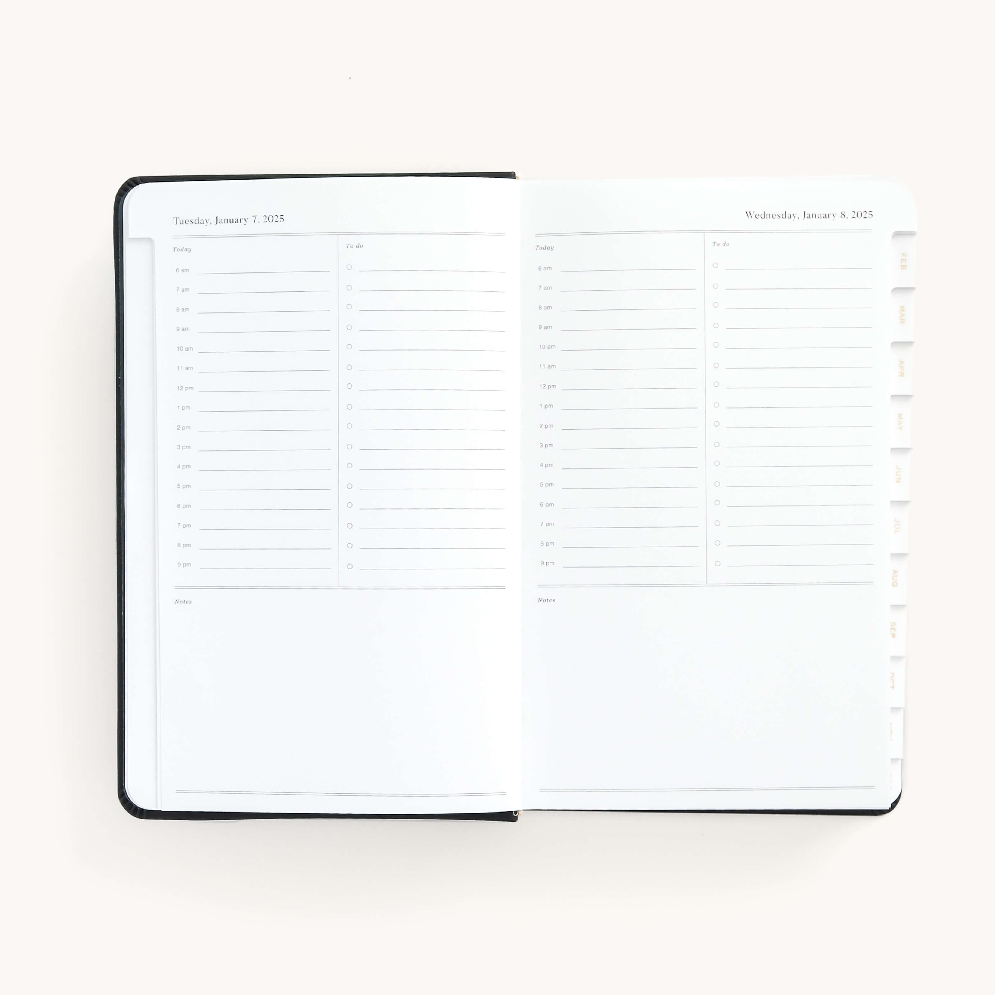 2025 Daily Dapperdesk Planner by Emily Ley in the Black Tie leatherette cover open to a two-page daily spread featuring Tuesday and Wednesday. Features a clean, minimalistic design with lined sections for daily tasks, to-do lists, and notes.