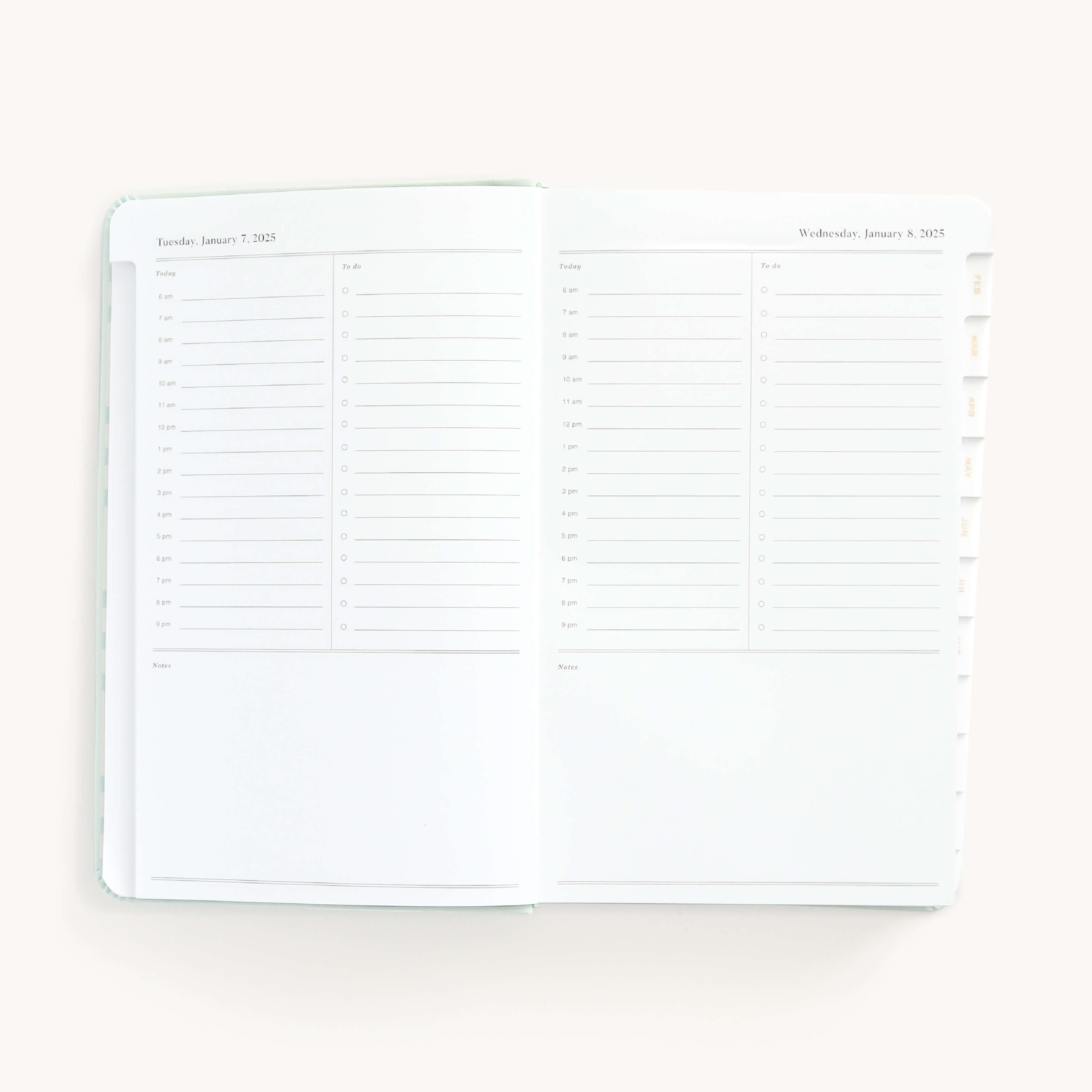 2025 Daily Dapperdesk Planner by Emily Ley in the Sea Salt leatherette cover open to a two-page daily spread featuring Tuesday and Wednesday. Features a clean, minimalistic design with lined sections for daily tasks, to-do lists, and notes.