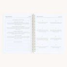 An open spiral-bound Simplified workbook titled Hosting features the left page with sections on event planning and gathering goals, while hosting tips fill the right. It boasts a clean layout, resembling a well-organized guide with ample white space.