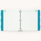 A light blue and white striped open binder, featuring Simplifieds Teal Big Kid Book-style dividers with blue polka dots, evokes the growth theme. The text is mysteriously unclear, sparking curiosity against the backdrop of a memorable design.