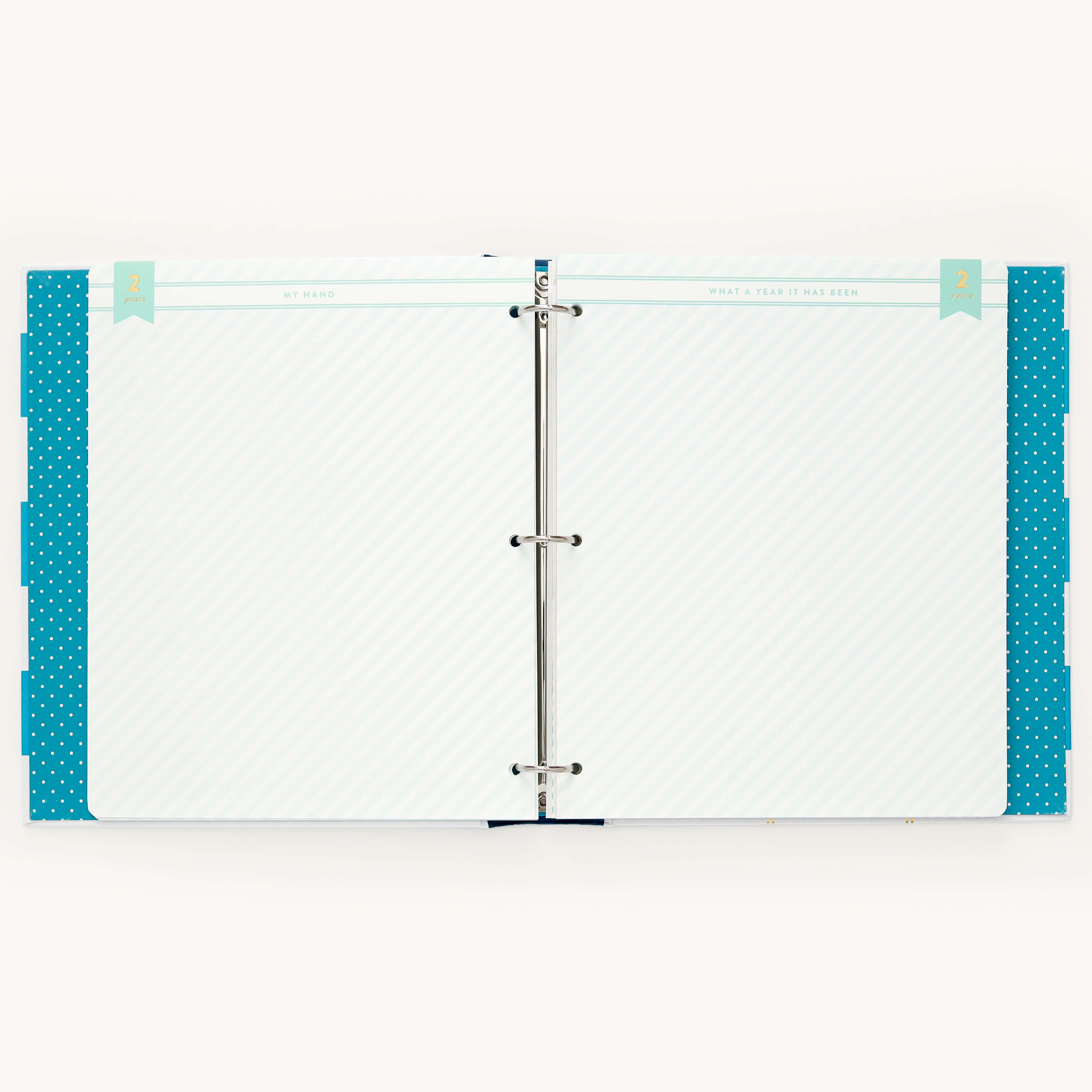 A light blue and white striped open binder, featuring Simplifieds Teal Big Kid Book-style dividers with blue polka dots, evokes the growth theme. The text is mysteriously unclear, sparking curiosity against the backdrop of a memorable design.