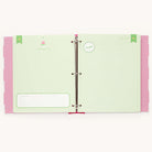 The Simplified Big Kid Book - Raspberry features colorful pages with a pastel green spread, including A Letter to You on the right and an All About Me form on the left. The playful pink polka dot cover edges and birthday hat graphic add charm.