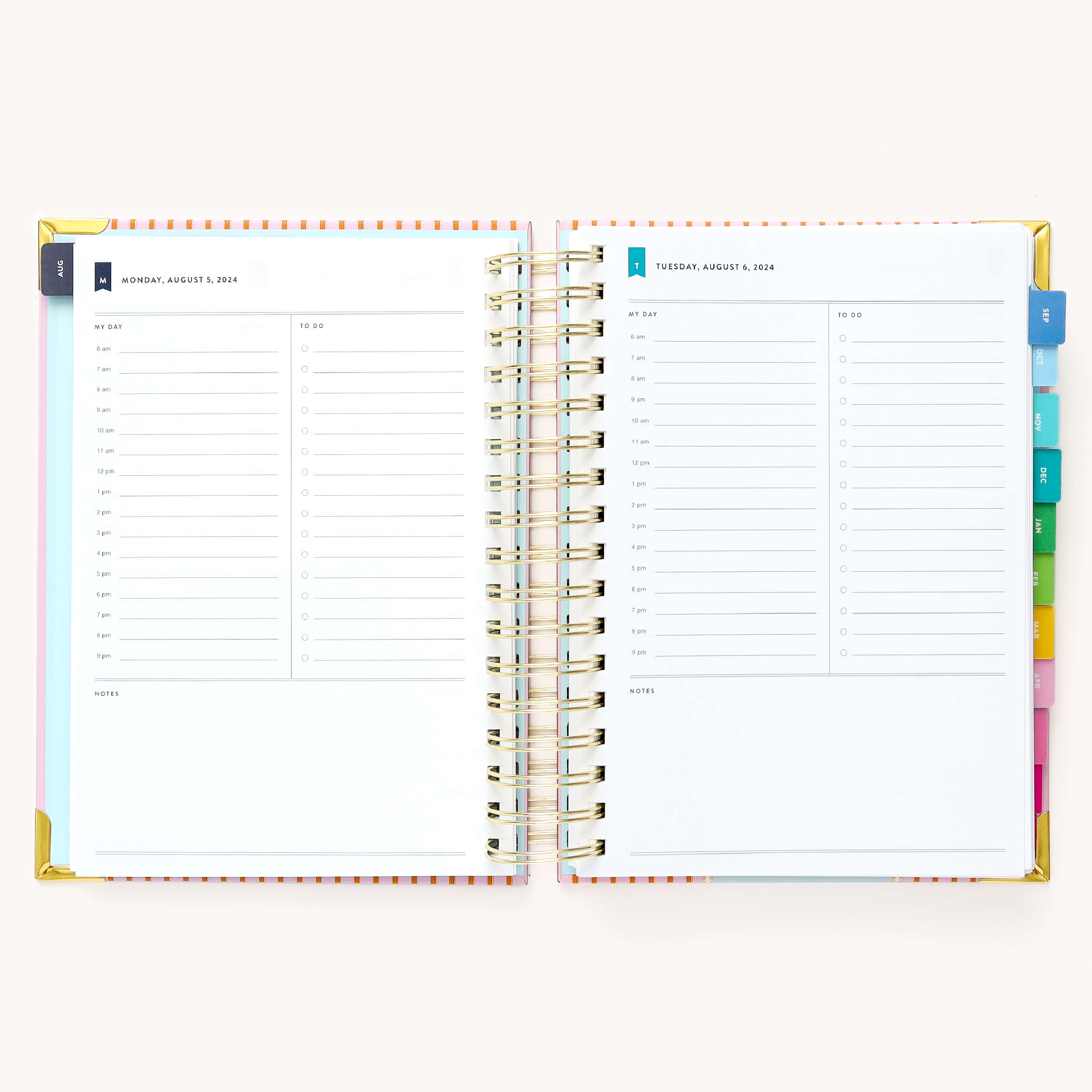 2024-2025 Daily Simplified Planner by Emily Ley in the Cabana Pinstripe cover design open to a two-page daily spread featuring Monday and Tuesday. Features a clean, minimalistic design with lined sections for daily tasks, to-do lists, and notes. Includes color-coded weekday labels, durable spiral binding, and gold corner protectors. 