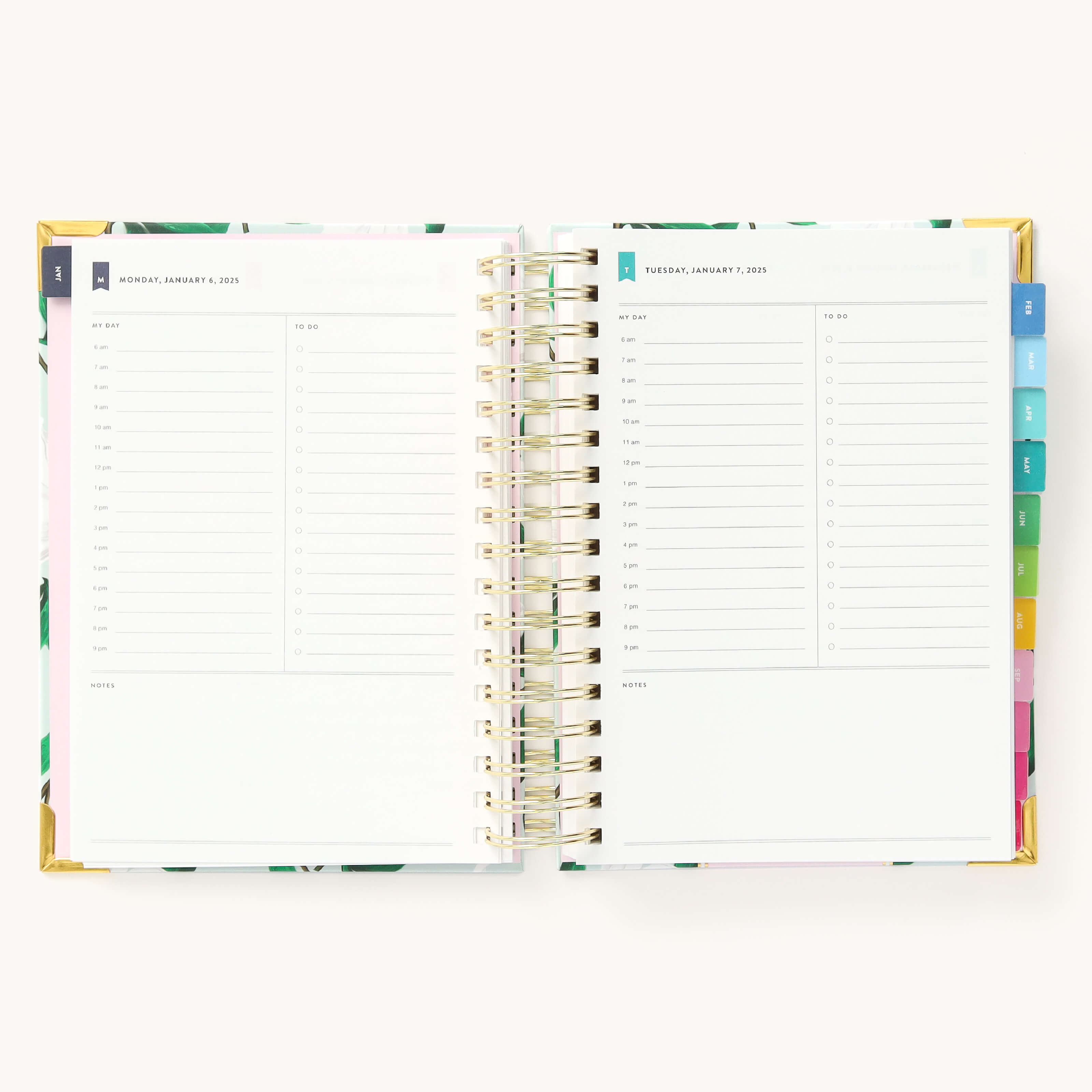 2025 Daily Simplified Planner by Emily Ley in the Savannah Blooms cover design open to a two-page daily spread featuring Monday and Tuesday. Features a clean, minimalistic design with lined sections for daily tasks, to-do lists, and notes. Includes color-coded weekday labels, durable spiral binding, and gold corner protectors. 