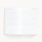 2025 Daily Dapperdesk Planner by Emily Ley in the Sea Salt leatherette cover open to a two-page daily spread featuring Thursday and Friday. Features a clean, minimalistic design with lined sections for daily tasks, to-do lists, and notes.