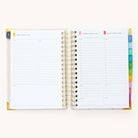 2024-2025 Daily Simplified Planner by Emily Ley in the Blush Block cover design open to a two-page weekend spread. Features a clean, minimalistic design with lined sections for daily tasks, to-do lists, and notes. Includes color-coded weekday labels, durable spiral binding, and gold corner protectors. 