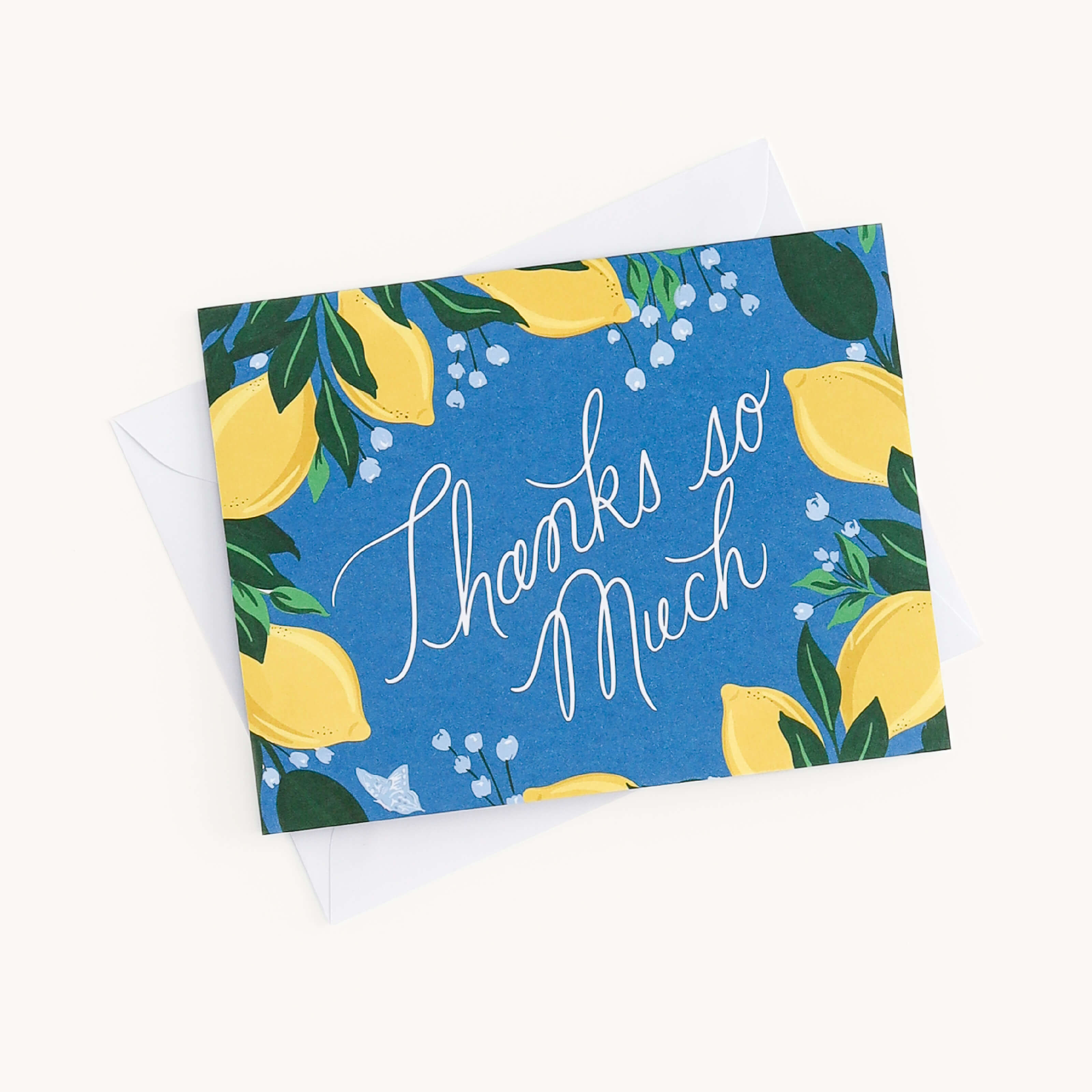 The Boxed Card Set from Simplified features a Thanks so Much card with white cursive on blue, adorned with yellow lemons and green leaves. It includes an envelope tucked beneath, making it perfect for any occasion.