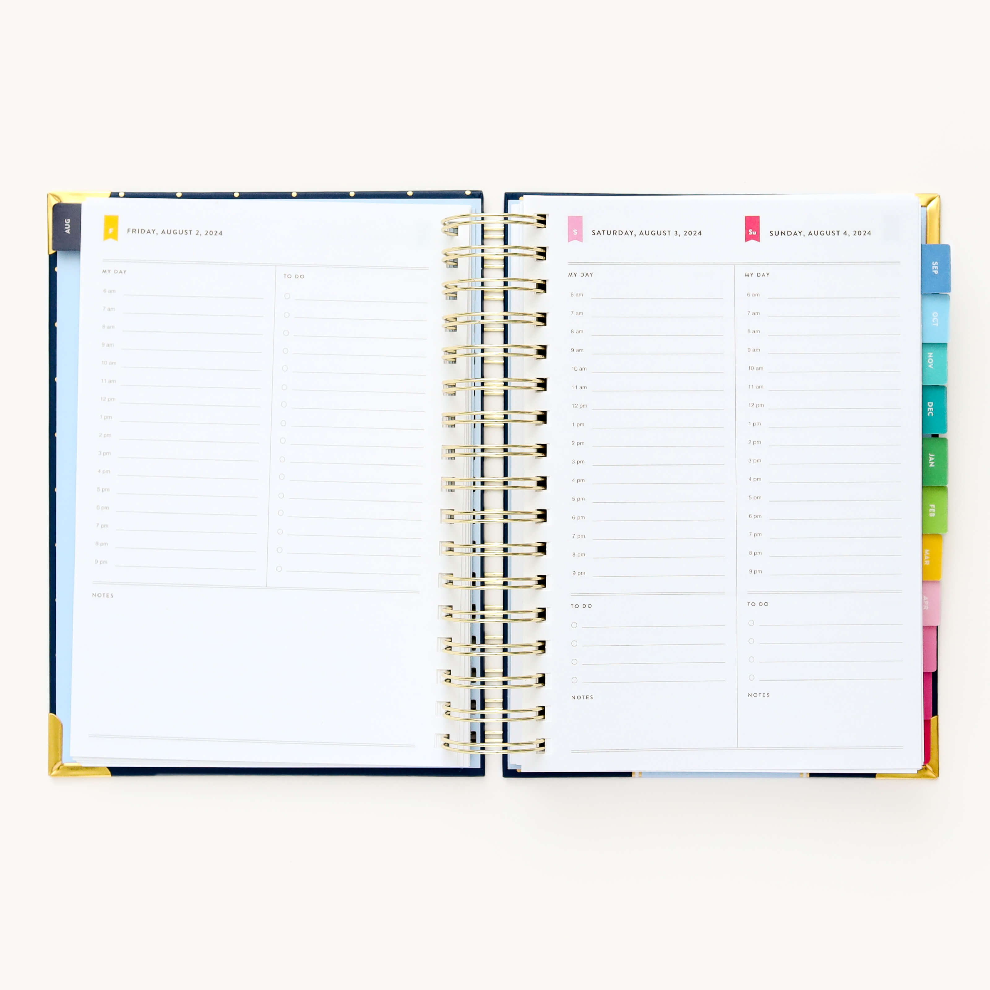 2024-2025 Daily Simplified Planner by Emily Ley in the Dainty Dot cover design open to a two-page weekend spread. Features a clean, minimalistic design with lined sections for daily tasks, to-do lists, and notes. Includes color-coded weekday labels, durable spiral binding, and gold corner protectors. 