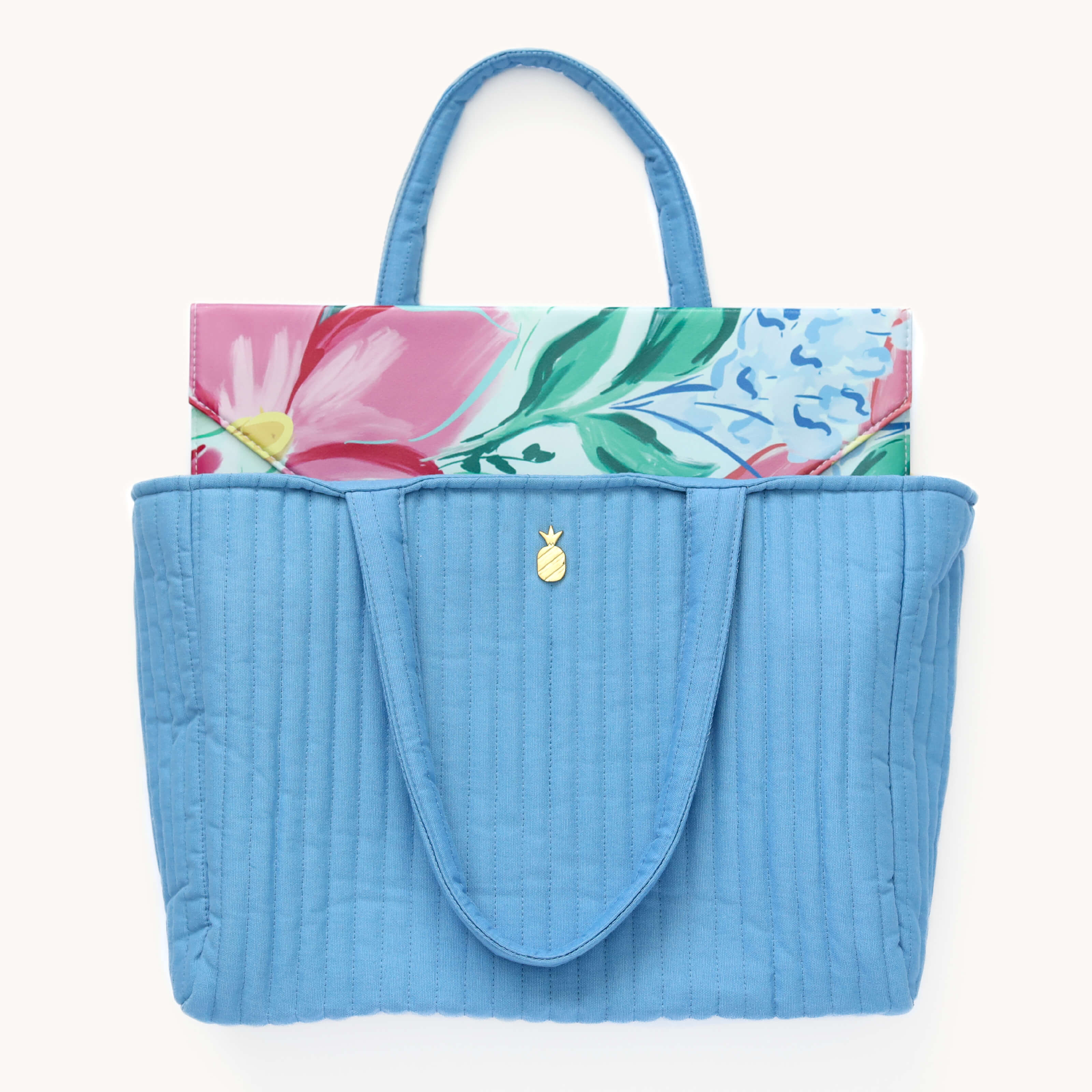 Blush Magnolia Tech Case peeking out from French Blue Quilted Tote Bag.