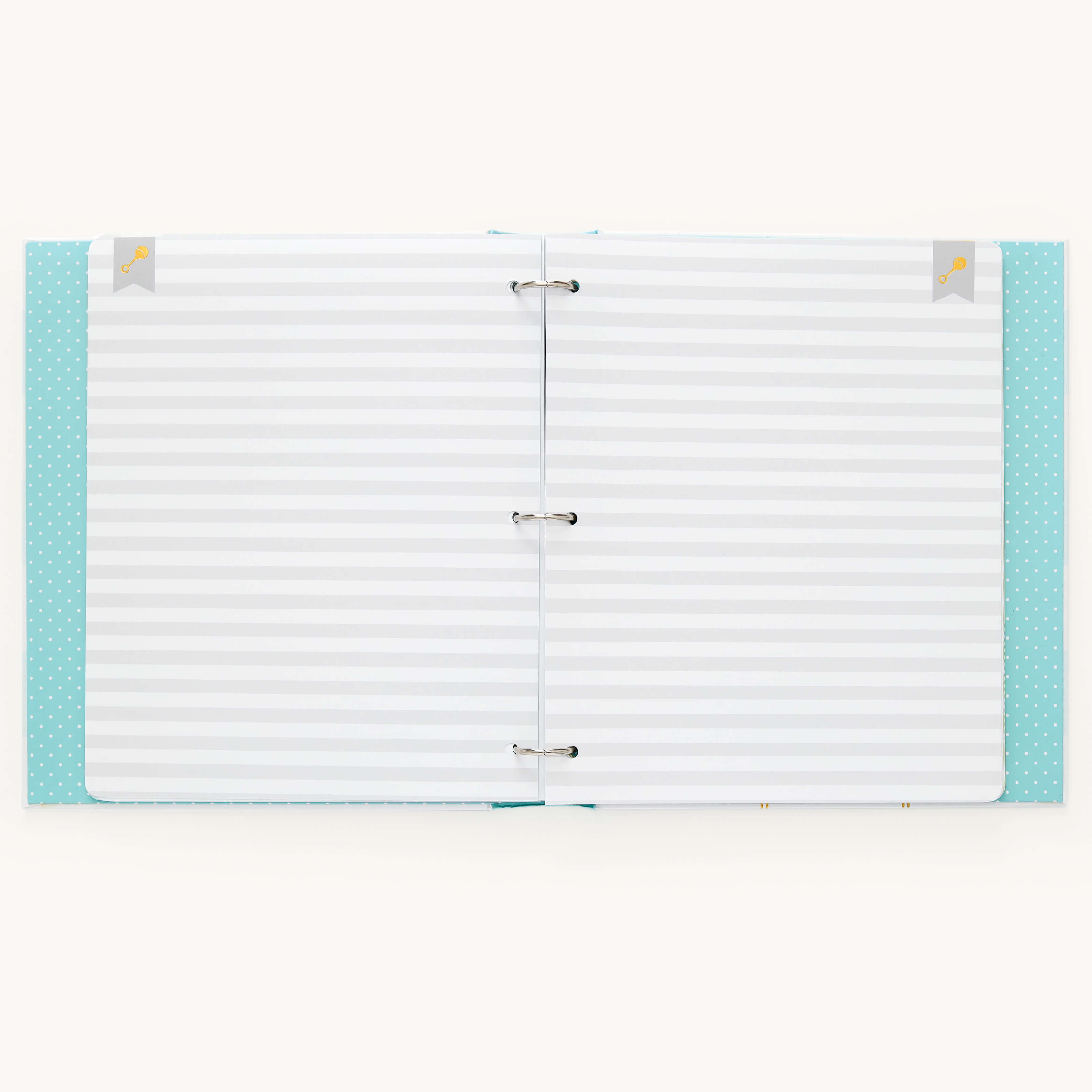 The Baby Book - Mint by Simplified features a turquoise polka dot cover with small bird icons. It opens flat, revealing lined paper in three-ring binding, ideal for capturing your little ones milestones with customizable page packs and guided writing space.