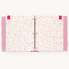 An open binder from Simplifieds Raspberry Big Kid Book reveals pages with a pink floral pattern on white, perfect for a childs adventures. Pink polka dot dividers add charm, making it ideal.