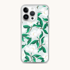 The iPhone Case - Savannah Blooms by Simplified showcases elegant white flowers and green leaves against a light blue background. This case features clear edges to highlight the floral design while providing exceptional phone protection.