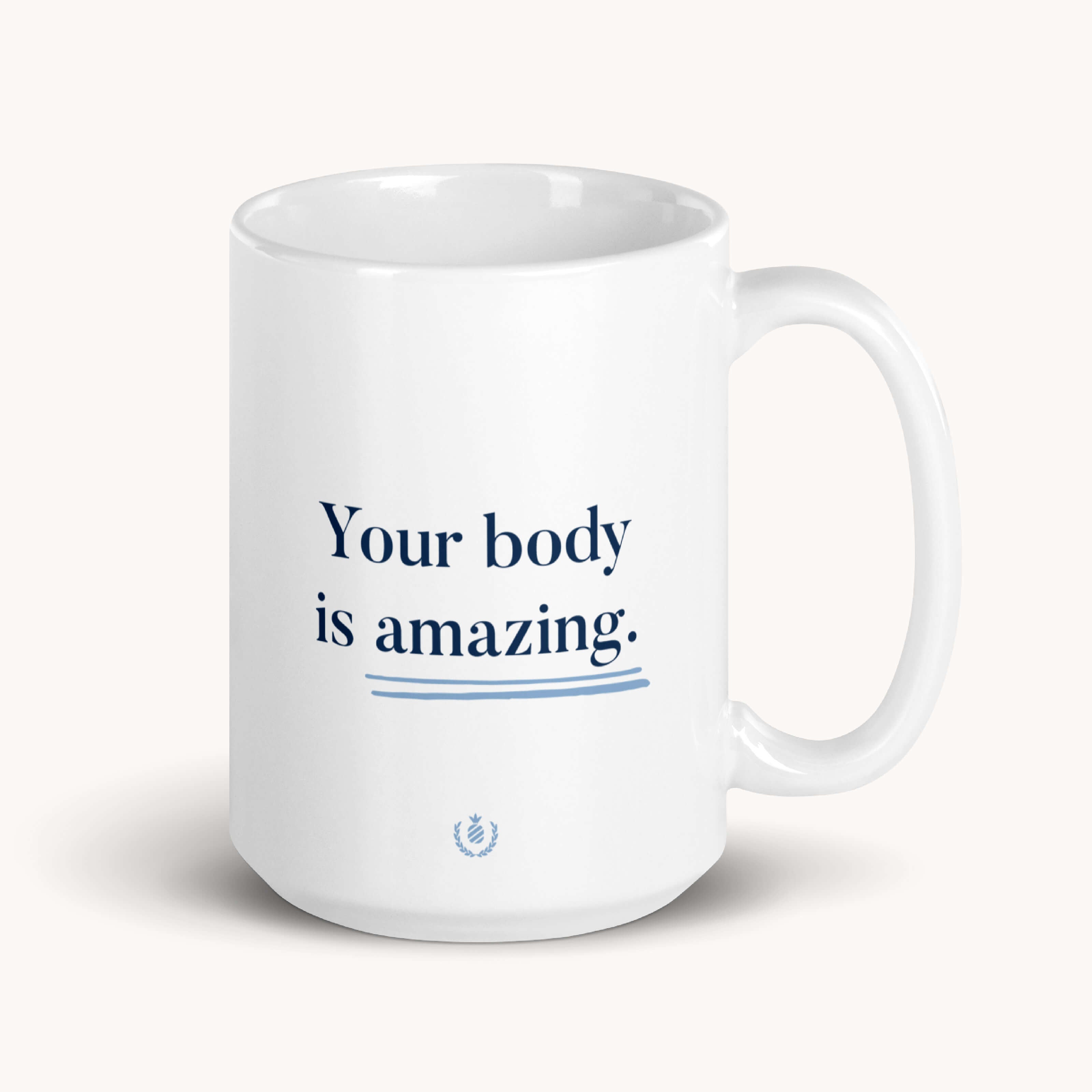 The Simplified Your Body Is Amazing mug is a white ceramic cup featuring blue text and a small emblem beneath it. It is microwave safe.