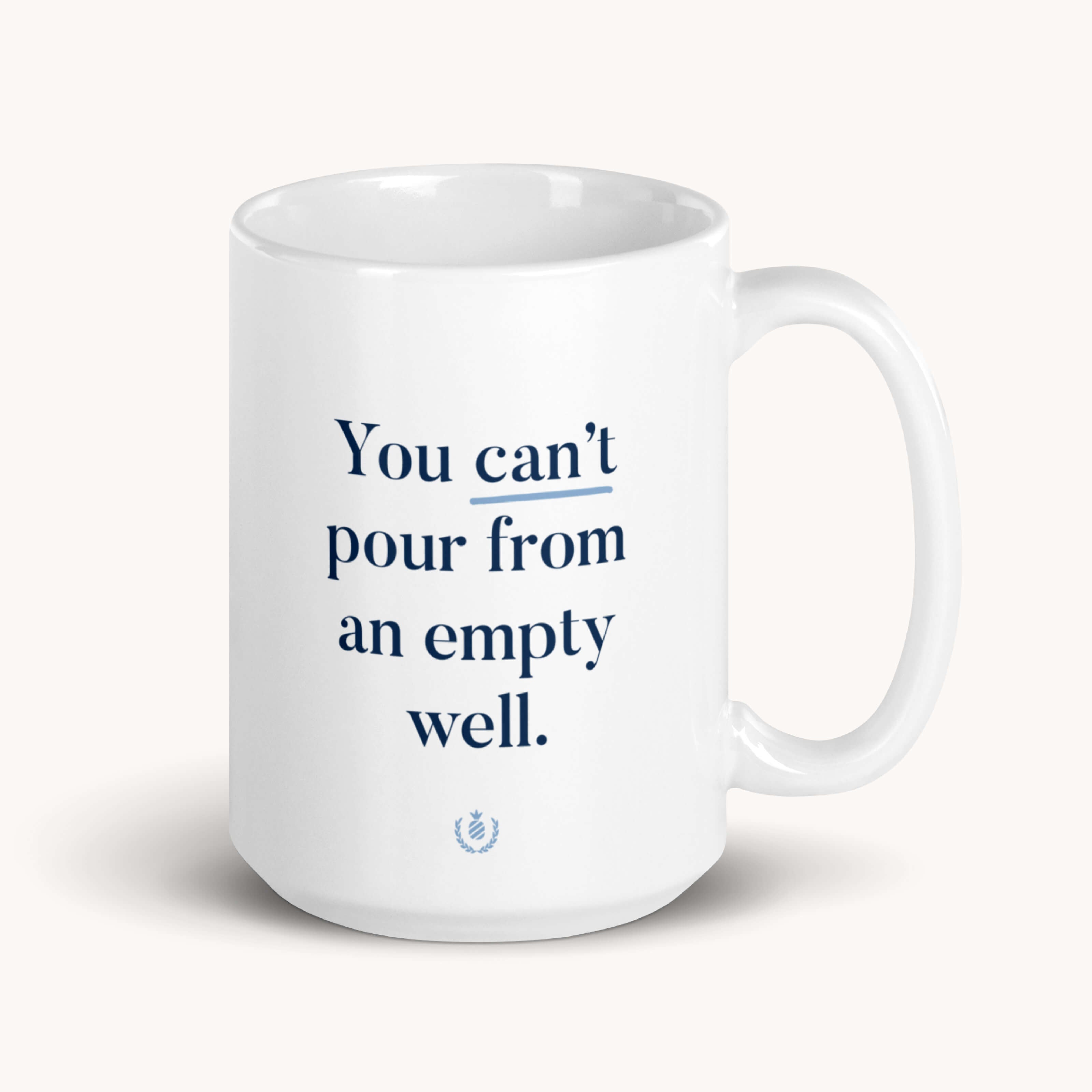 The Simplified Mug - Empty Well is a 15 oz. white ceramic mug that is dishwasher-safe and features the phrase You cant pour from an empty well in bold blue text.