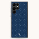 The navy Samsung Case - Dainty Dot by Simplified features chic small white polka dots, a prominent top-left camera setup, and a bottom-center white S logo for protection and style.