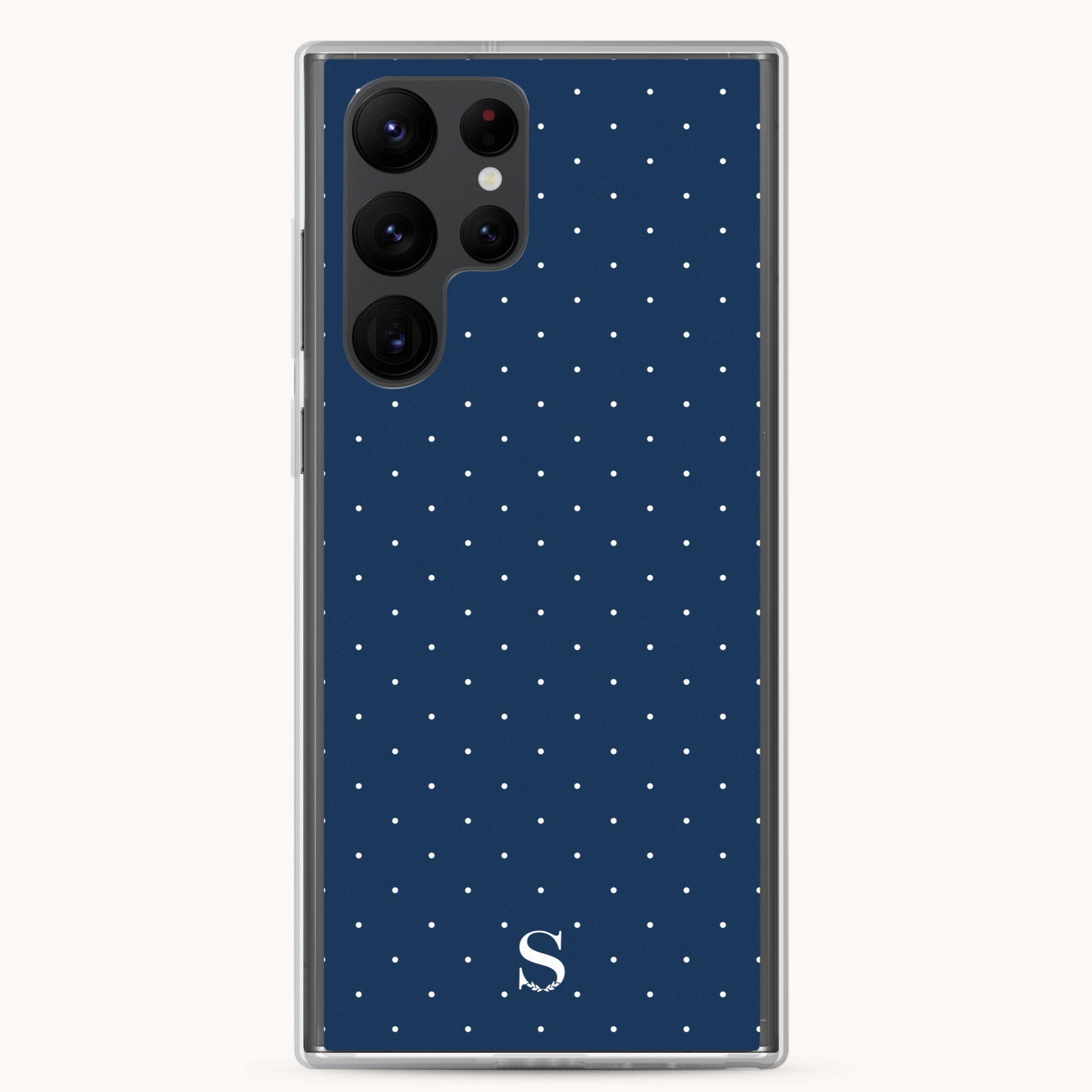 The navy Samsung Case - Dainty Dot by Simplified features chic small white polka dots, a prominent top-left camera setup, and a bottom-center white S logo for protection and style.