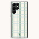 Explore the Samsung Case - Pistachio Plaid by Simplified, featuring a chic light green plaid design with white and gray accents. The transparent edges highlight an S logo, while providing protection and accommodating multiple camera lenses on the top left corner.